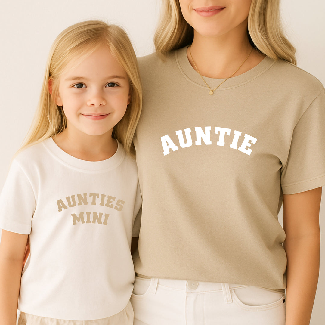 Two people wearing matching shirts with 'AUNTIE' and 'AUNTIES MINI' text.