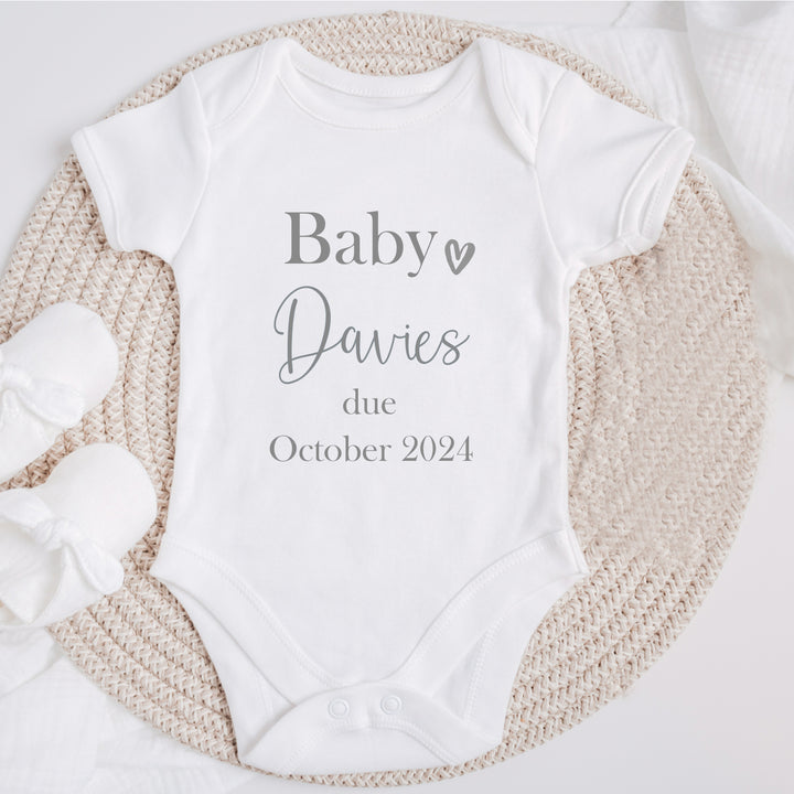 Baby announcement vests that says: 'Baby Davies due October 2025'