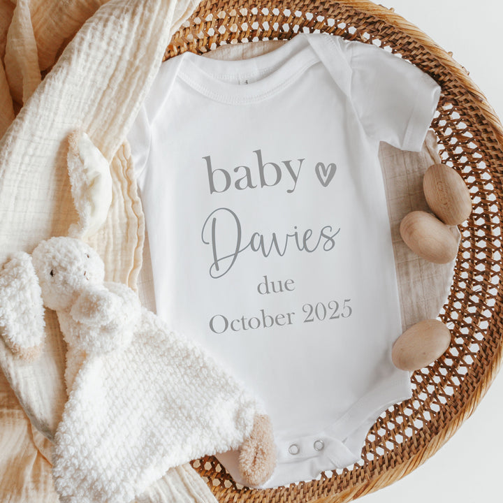 Baby announcement vests that says: 'Baby Davies due October 2025'