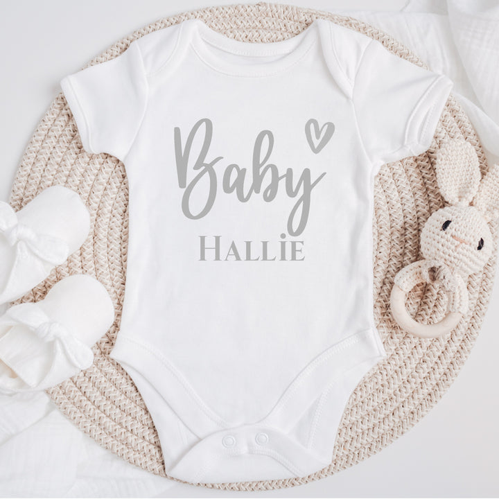 Baby announcement vests that says: 'Baby Hallie' with a heart