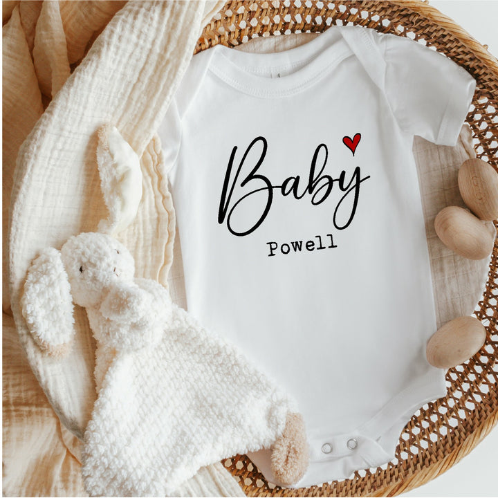 Baby announcement vests that says: Baby Powell with a red heart