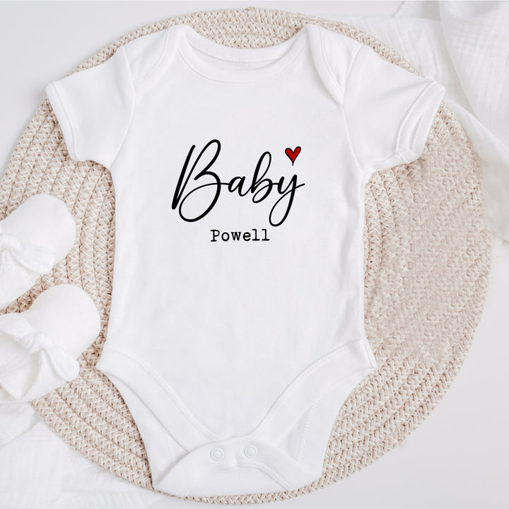 Baby announcement vests that says: Baby Powell with a red heart