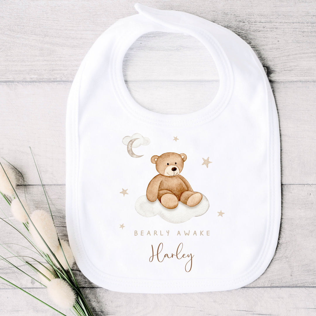 A personalised white baby vest that says 'Baarly Awake Harley'. This design features a bear sitting on a cloud