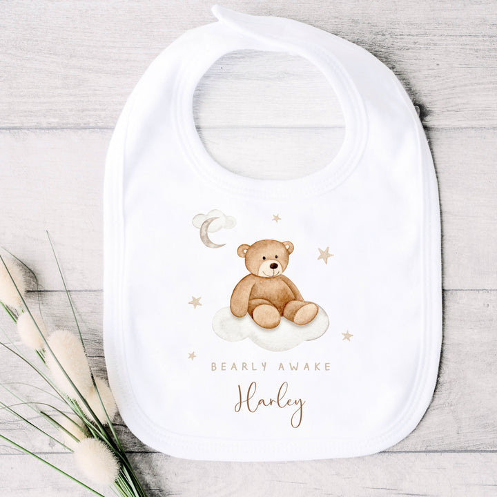 A personalised white baby vest that says 'Baarly Awake Harley'. This design features a bear sitting on a cloud