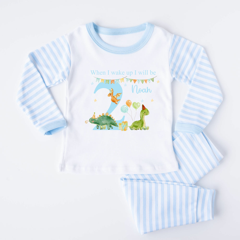 Blue Stripe birthday pyjamas that say 'When I wake up I will be 2 Noah'. This design features dinosaurs wearing party hats 