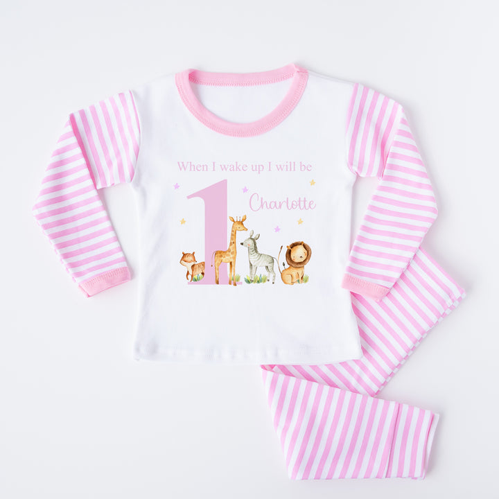 Personalised pink stripe birthday pyjamas that say 'When I wake up I will be 1 Charlotte'. This design features a big pink 1 with jungle animals around it 