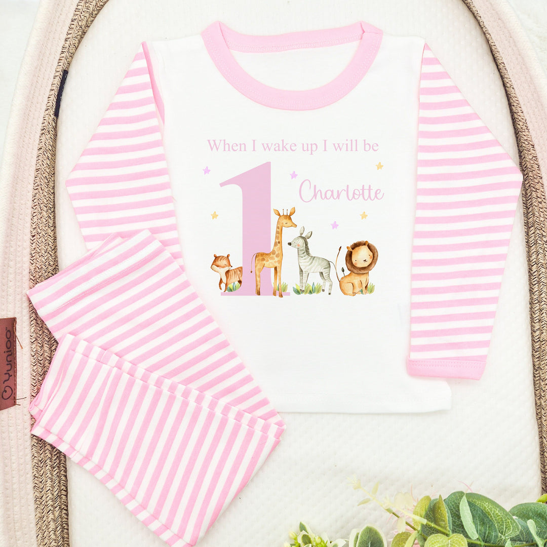 Personalised pink stripe birthday pyjamas that say 'When I wake up I will be 1 Charlotte'. This design features a big pink 1 with jungle animals around it 