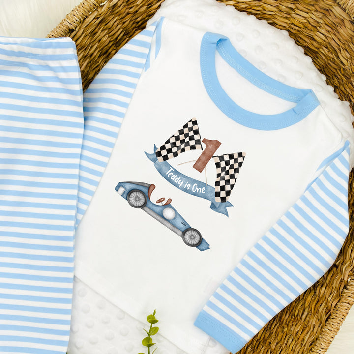 Blue Stripe birthday pyjamas that say 'Teddy is Two'. This design features a blue racecar 