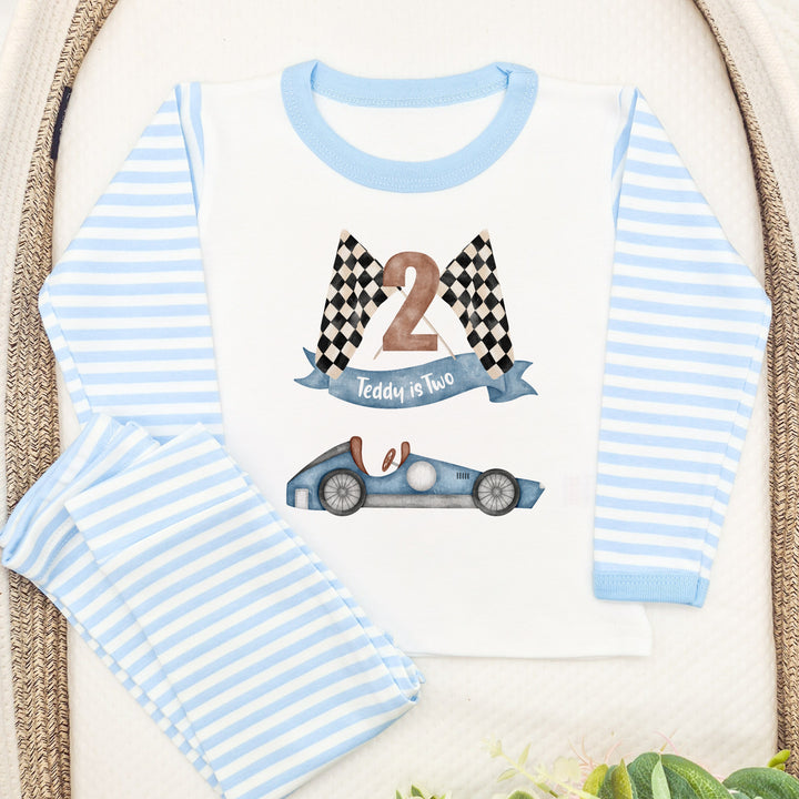 Blue Stripe birthday pyjamas that say 'Teddy is Two'. This design features a blue racecar 