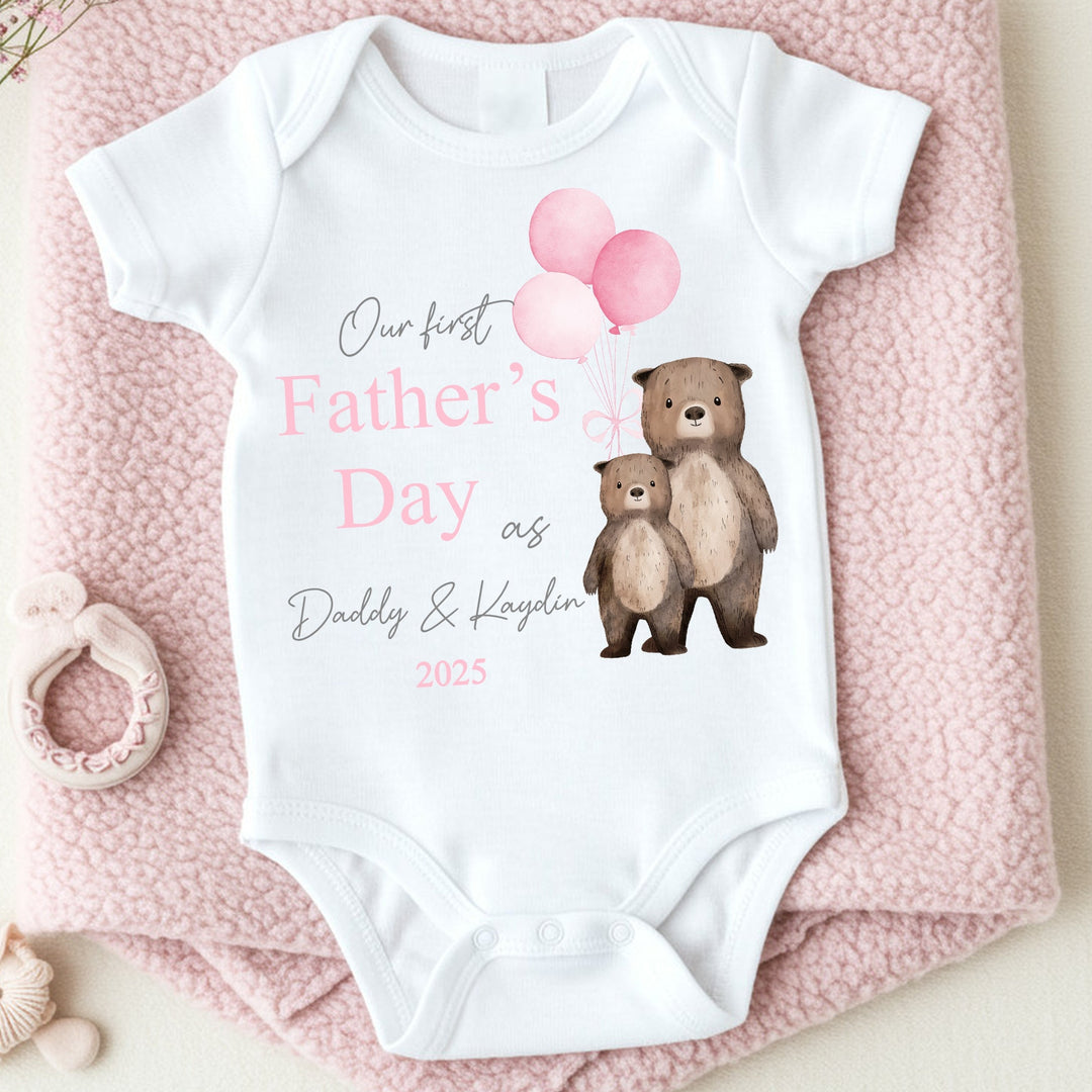 Personalised white Father's Day baby vest that says 'Our First Father's Day as Daddy & Kaydin 2025'. This design features 2 brown bears holding 3 pink balloons