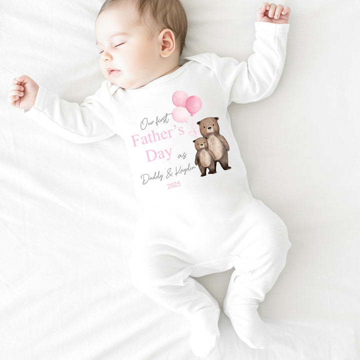 Personalised white Father's Day baby grow/sleepsuit that says 'Our First Father's Day as Daddy & Kaydin 2025'. This design features 2 brown bears holding 3 pink balloons