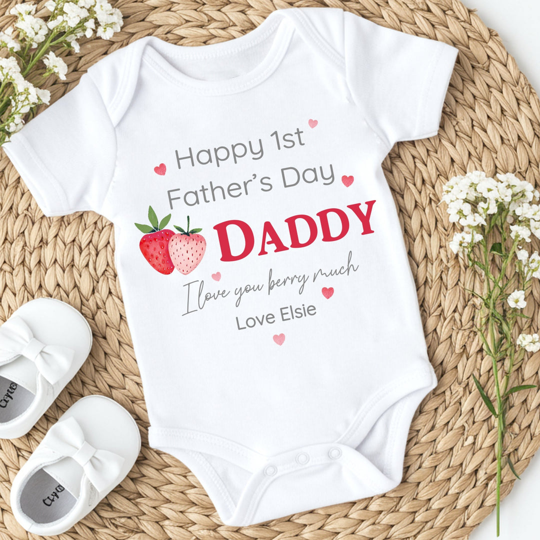 Personalised white Father's Day baby vest that says 'Happy 1st Father's Day Daddy I love you berry much Love Elsie'. This design features 2 strawberries and pink hearts