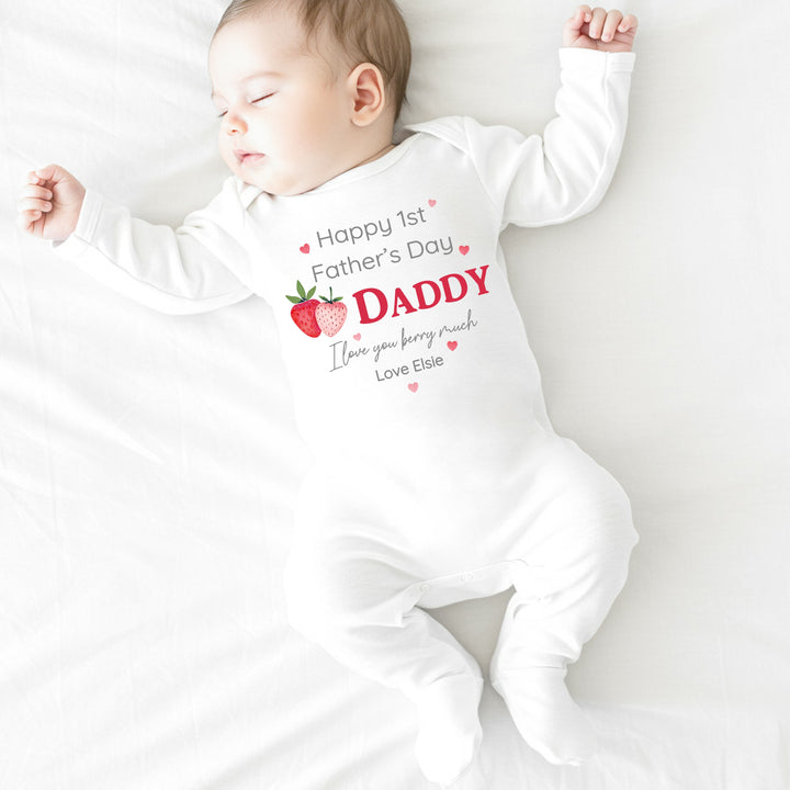 Personalised white Father's Day baby grow/sleepsuit that says 'Happy 1st Father's Day Daddy I love you berry much Love Elsie'. This design features 2 strawberries and pink hearts