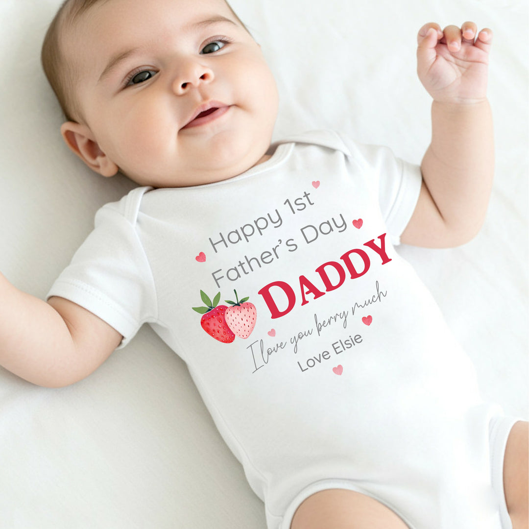 Personalised white Father's Day baby vest that says 'Happy 1st Father's Day Daddy I love you berry much Love Elsie'. This design features 2 strawberries and pink hearts