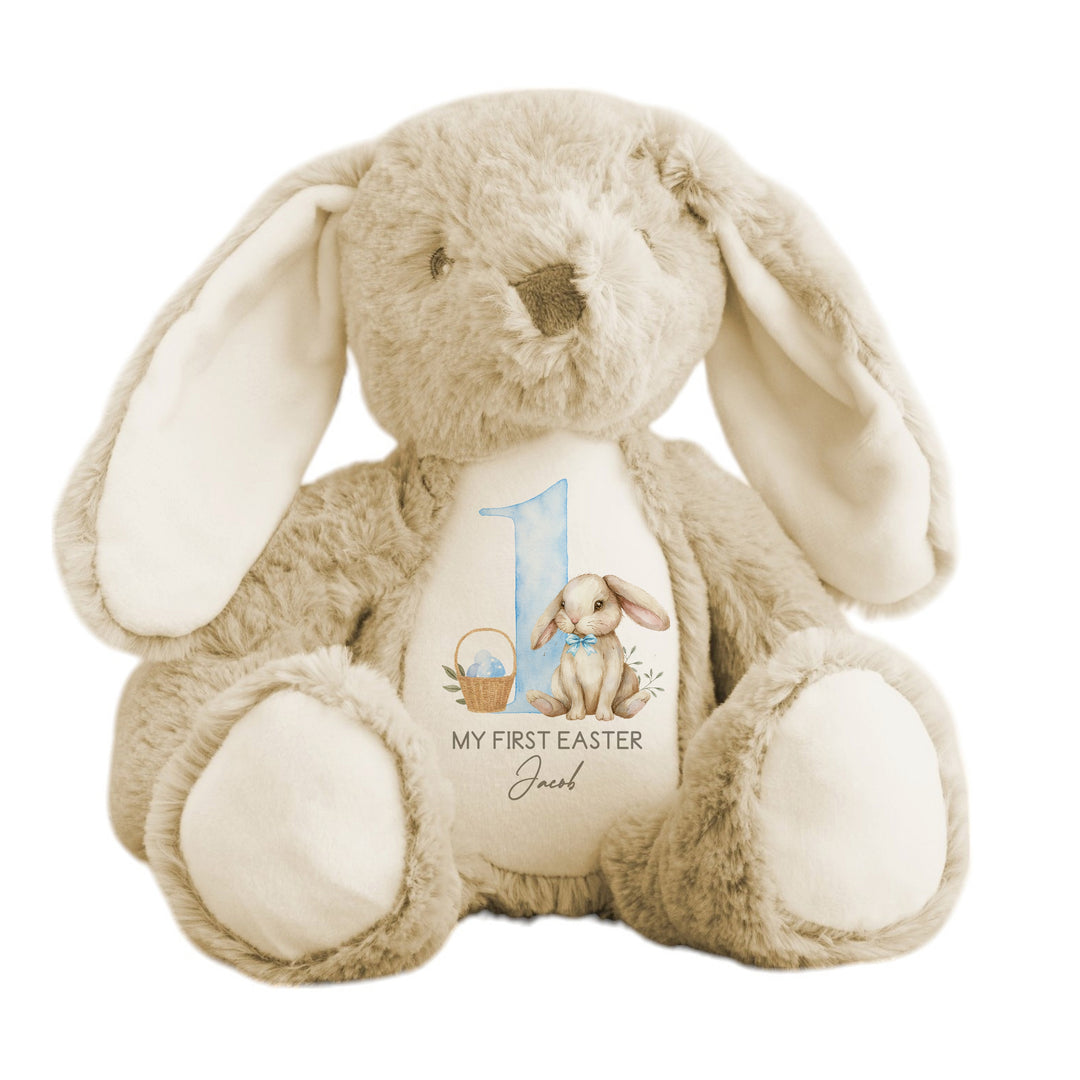 Personalised beige bunny Easter teddy that says 'My First Easter Jacob'. This design features a big blue 1 with a bunny sitting next to it wearing a blue bow tie and an Easter basket