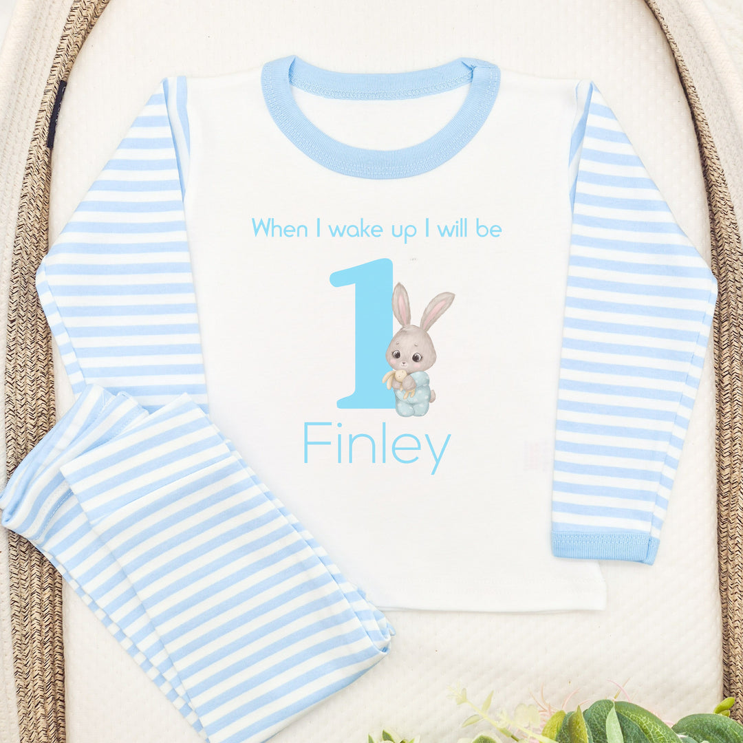 Blue Stripe birthday pyjamas that say 'When I wake up I will be 1 Finley'. This design features a big blue 1 and a bunny  in blue pyjamas