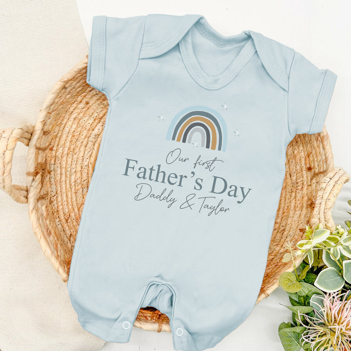 Personalised blue Father's Day romper that says 'Our First Father's Day Daddy & Taylor'. This design features a blue rainbow 