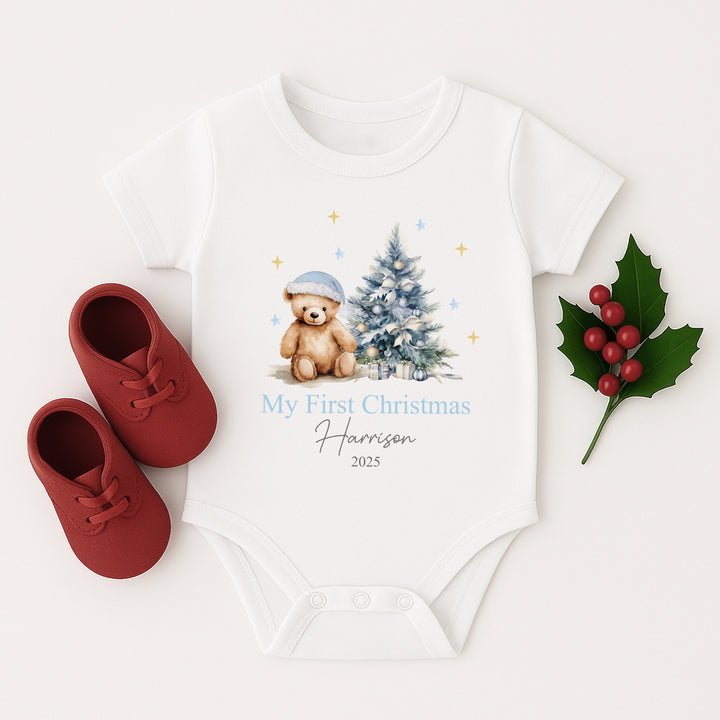 Baby onesie with Christmas design and red shoes on a white background