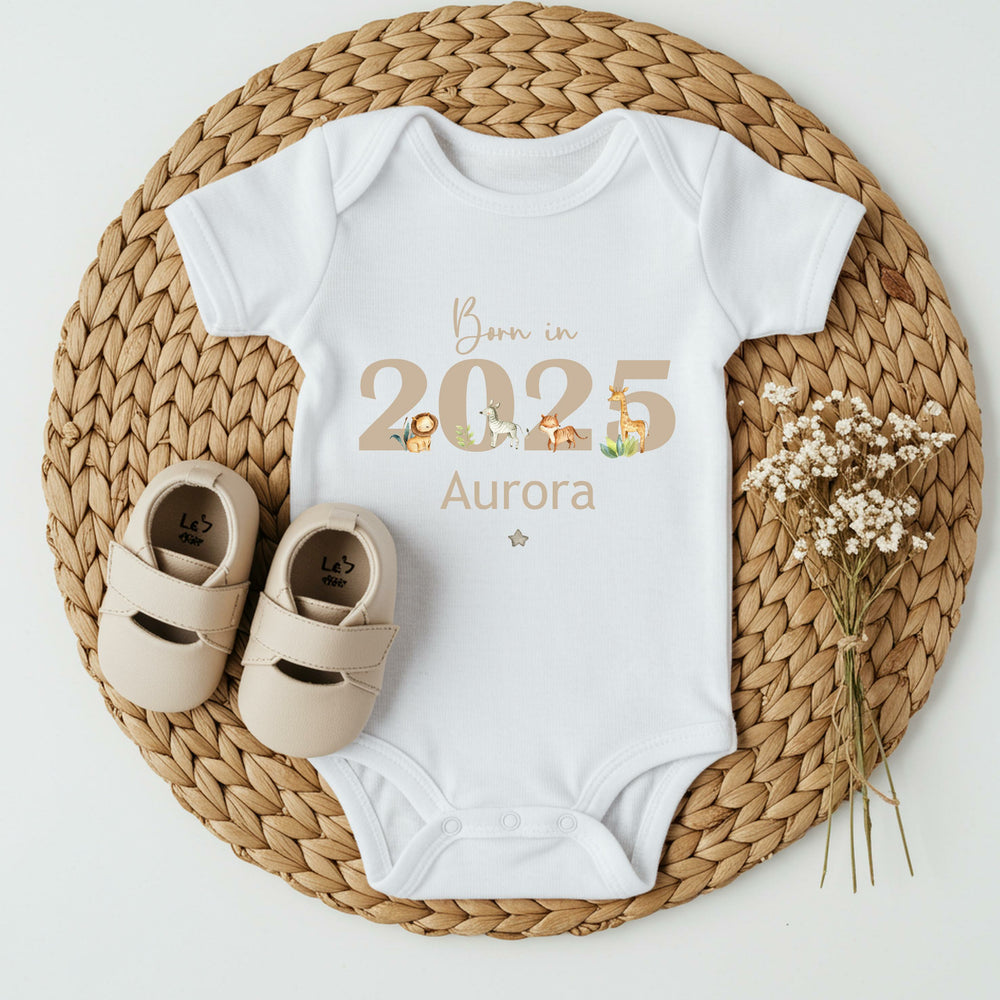 Personalised white baby vest that says 'Born in 2025 Aurora' in beige. This design features safari animals around the 2025