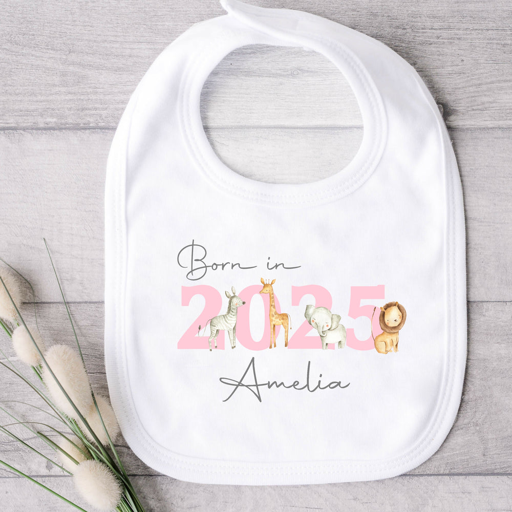 a personalised white baby bib that says 'Born in 2025 Amelia'. This design features safari animals