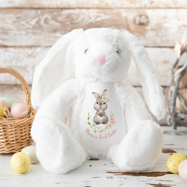 Personalised white bunny wreath Easter teddy that says 'Maisie's First Easter'. This design features a grey bunny in a pink floral wreath