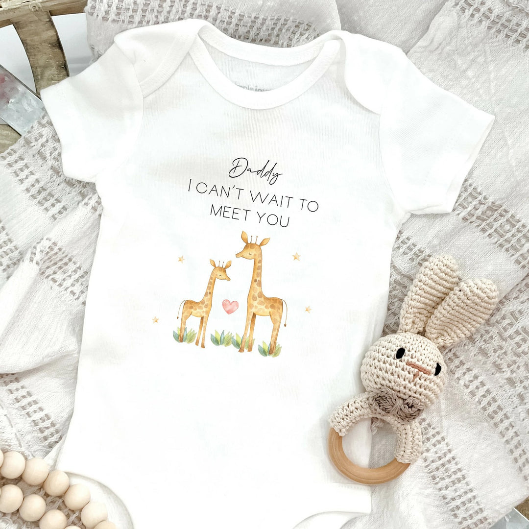 Baby announcement vests that says: Daddy I can't wait to meet you. With a daddy giraffe and a baby giraffe under the text