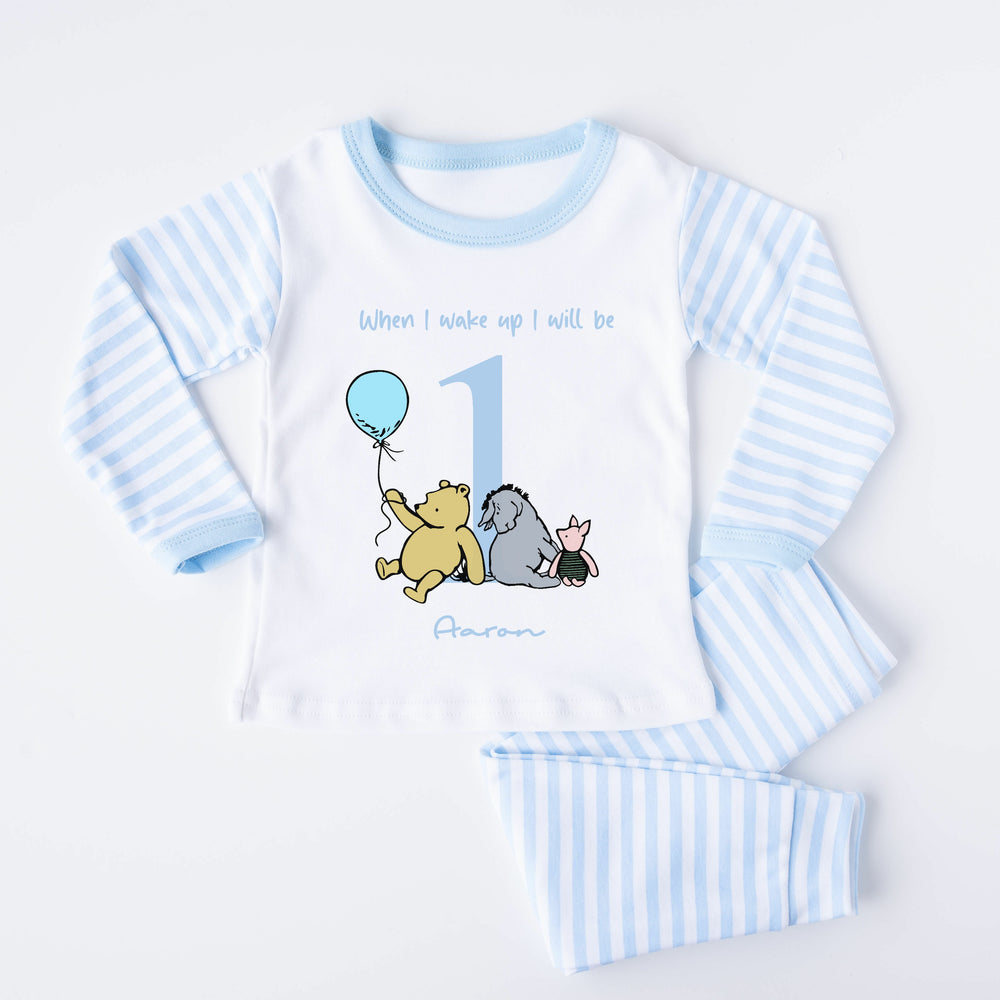 Blue Stripe birthday pyjamas that say 'When I wake up I will be 1 Aaron'. This design features the Classic Winnie the Pooh, Piglet and Eyore