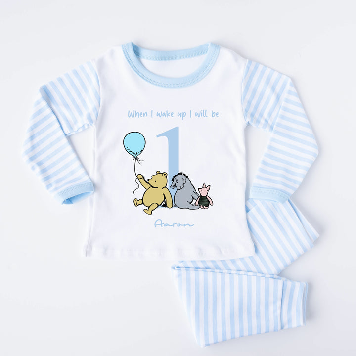 Blue Stripe birthday pyjamas that say 'When I wake up I will be 1 Aaron'. This design features the Classic Winnie the Pooh, Piglet and Eyore