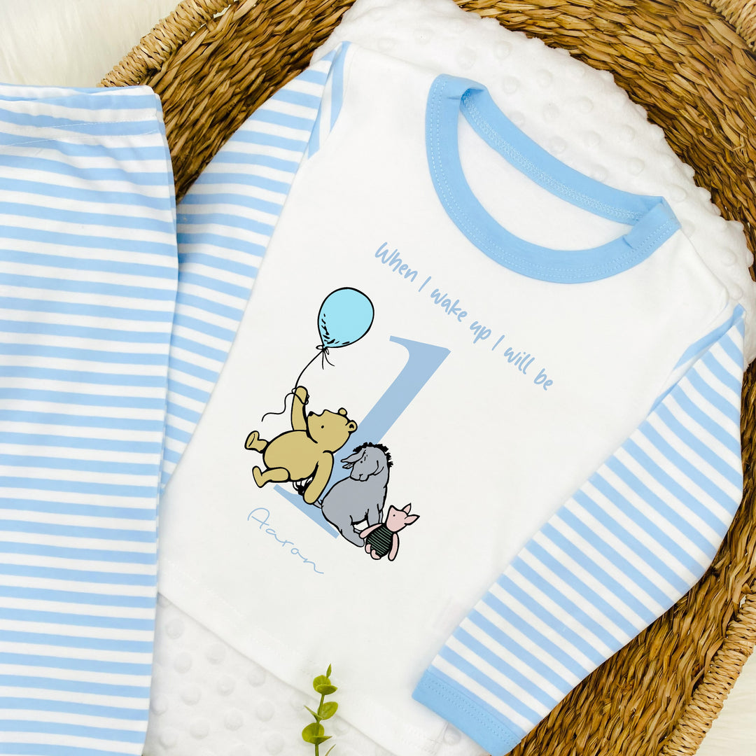 Blue Stripe birthday pyjamas that say 'When I wake up I will be 1 Aaron'. This design features the Classic Winnie the Pooh, Piglet and Eyore