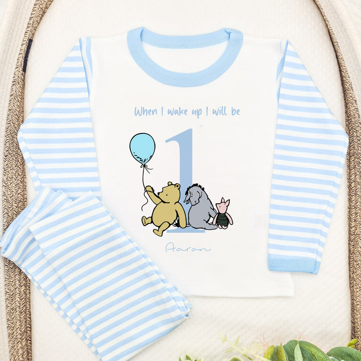 Blue Stripe birthday pyjamas that say 'When I wake up I will be 1 Aaron'. This design features the Classic Winnie the Pooh, Piglet and Eyore