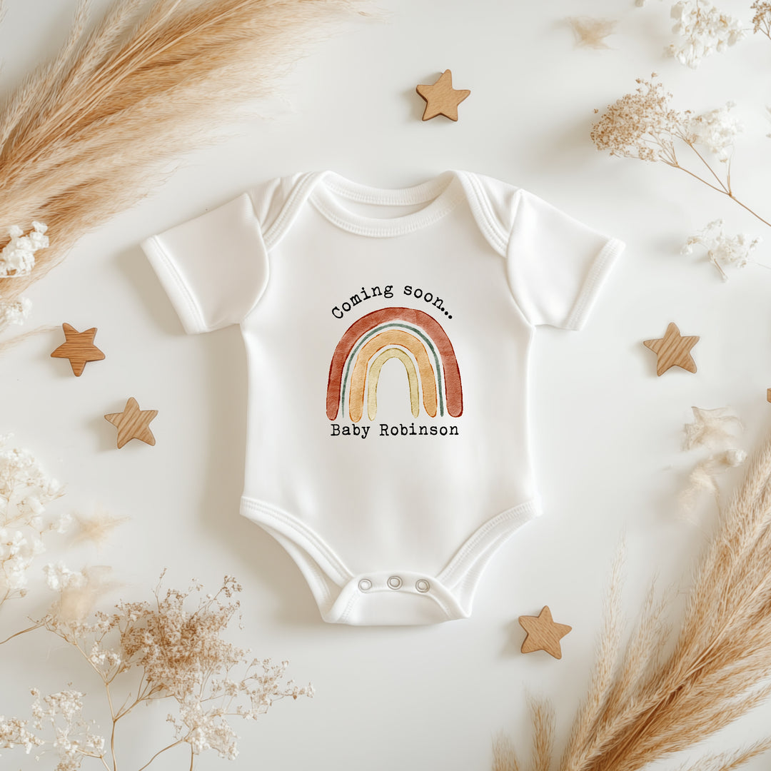 Baby announcement vests that says: 
Coming soon... Baby Robinson with a rainbow in the middle 