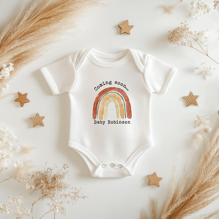 Baby announcement vests that says: 
Coming soon... Baby Robinson with a rainbow in the middle 