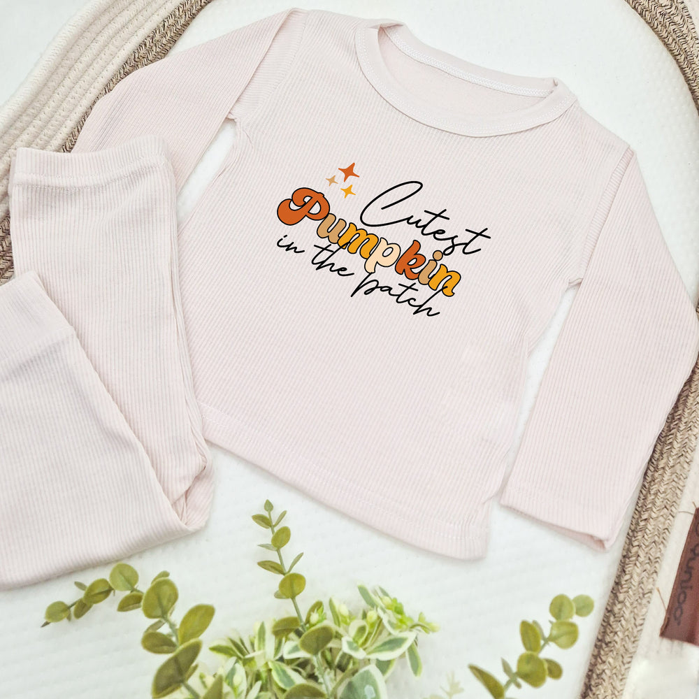 Pink baby outfit with 'Cutest Pumpkin' text on a white background