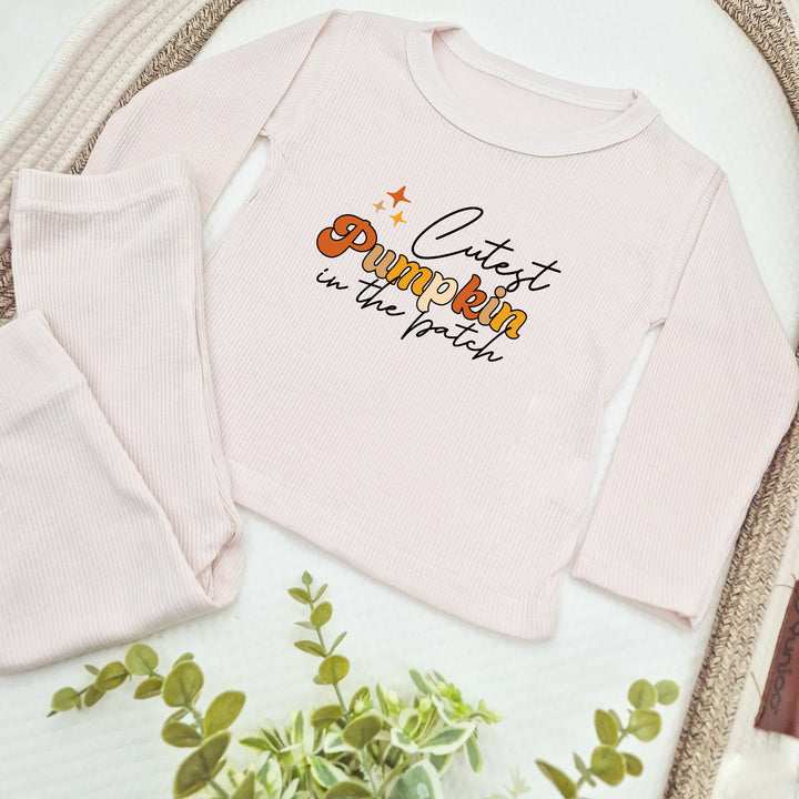 Pink baby outfit with 'Cutest Pumpkin' text on a white background