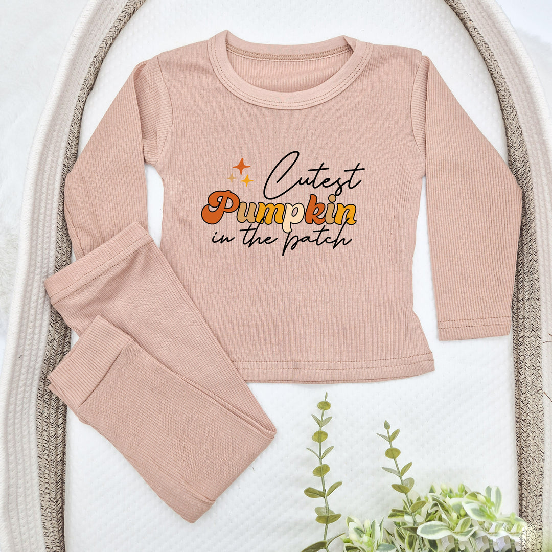 Pink children's outfit with 'Cutest Pumpkin in the Patch' text on a white background