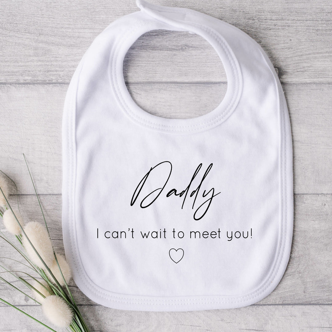 Baby bib that says: Daddy I can't wait to meet you! With a small heart under