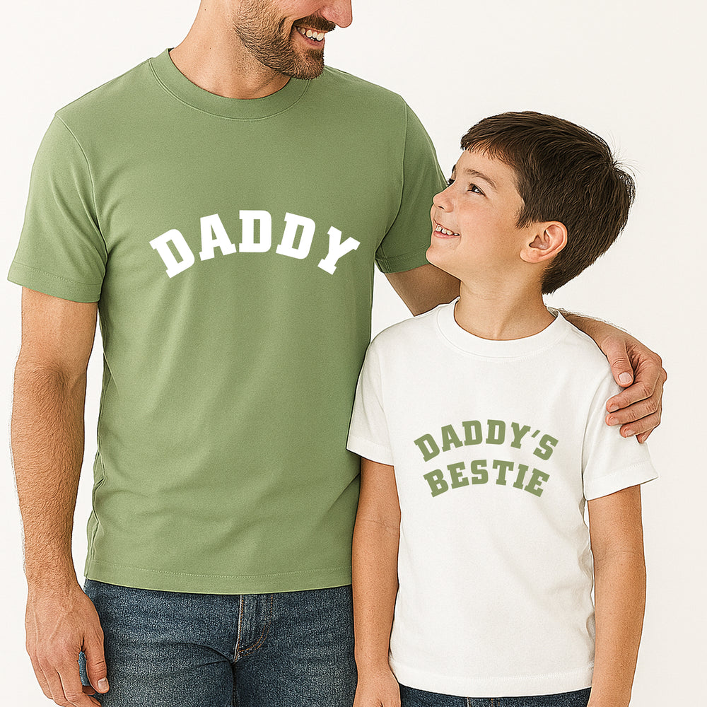 Man and child wearing matching shirts with 'DADDY' and 'DADDY'S BESTIE' text.