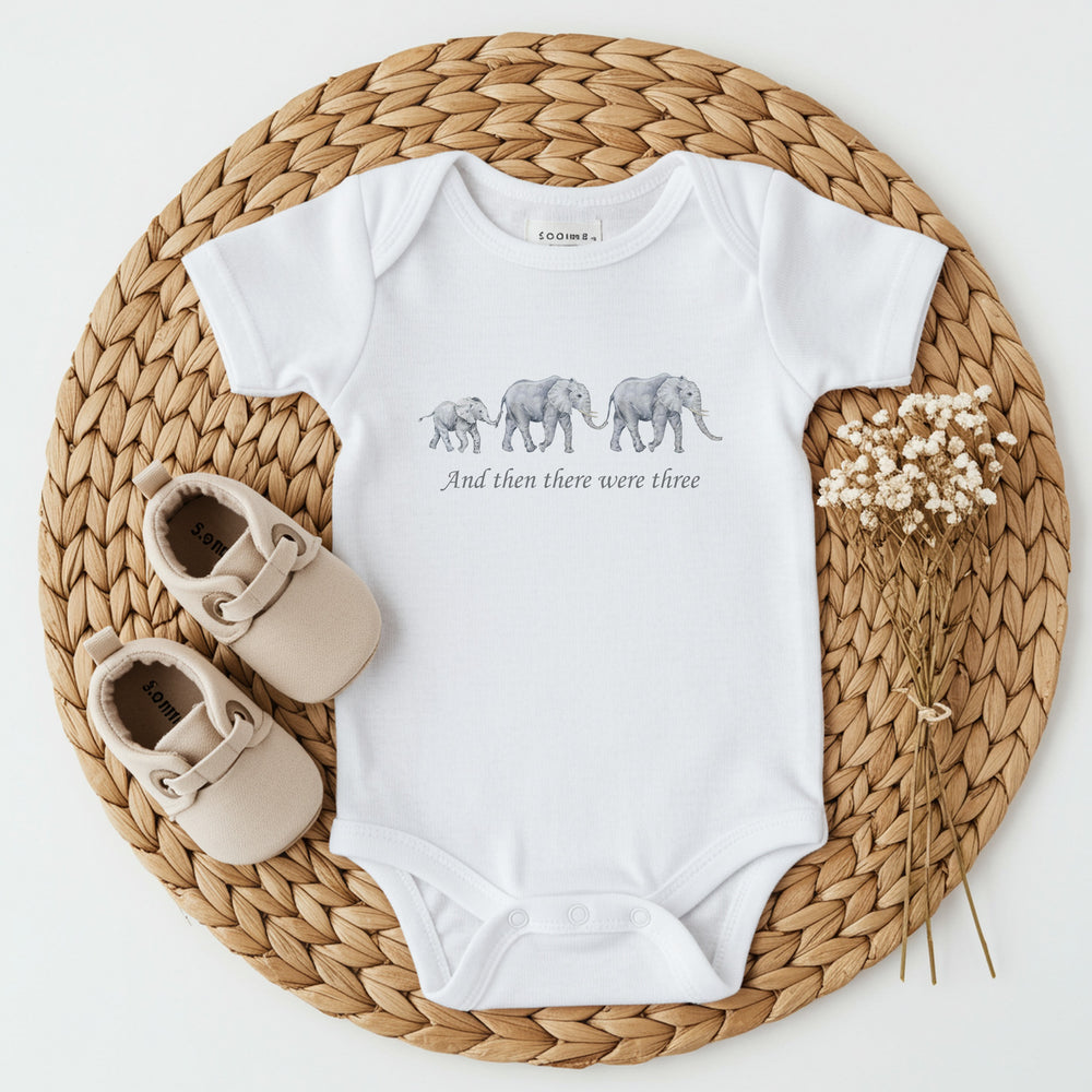 Baby announcement vests that says: 'And then there were three' with 3 elephant above