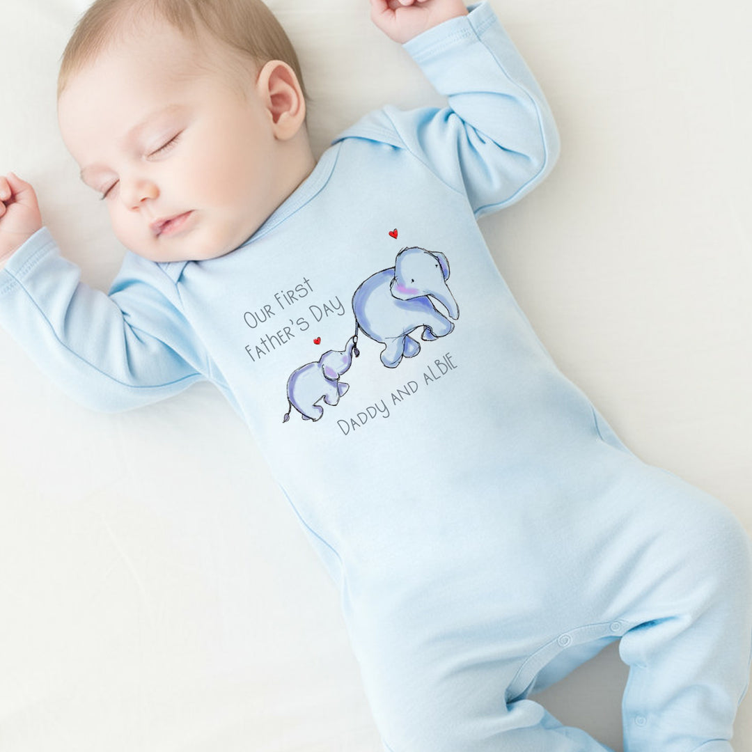 Personalised blue Father's Day baby grow/sleepsuit that says 'Our First Father's Day Daddy & Albie'. This design features 2 blue elephants