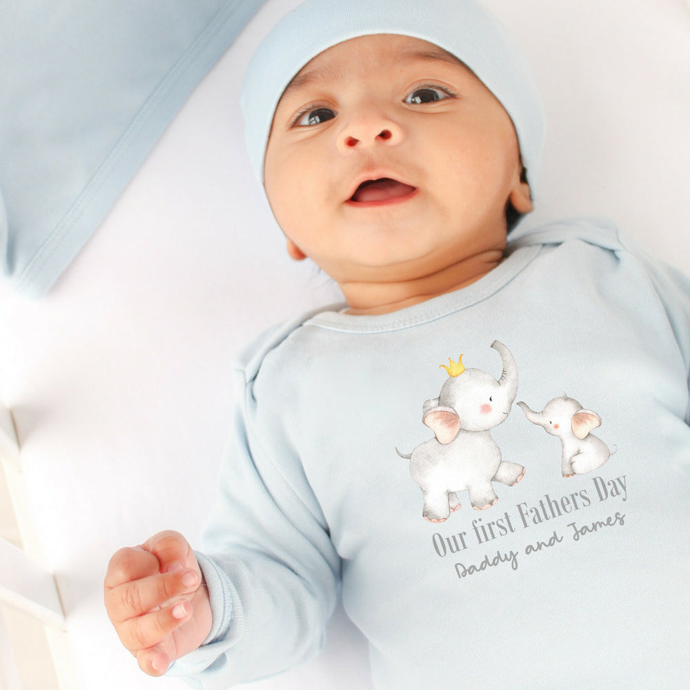 Personalised blue Father's Day baby grow that says 'Our First Father's Day Daddy and James'. This design features 2 elephants