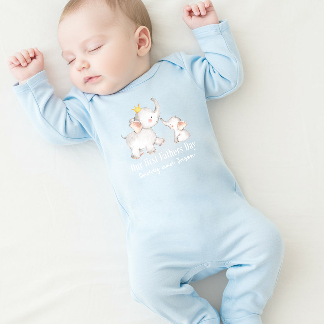 Personalised blue Father's Day baby grow that says 'Our First Father's Day Daddy and Jason'. This design features 2 elephants