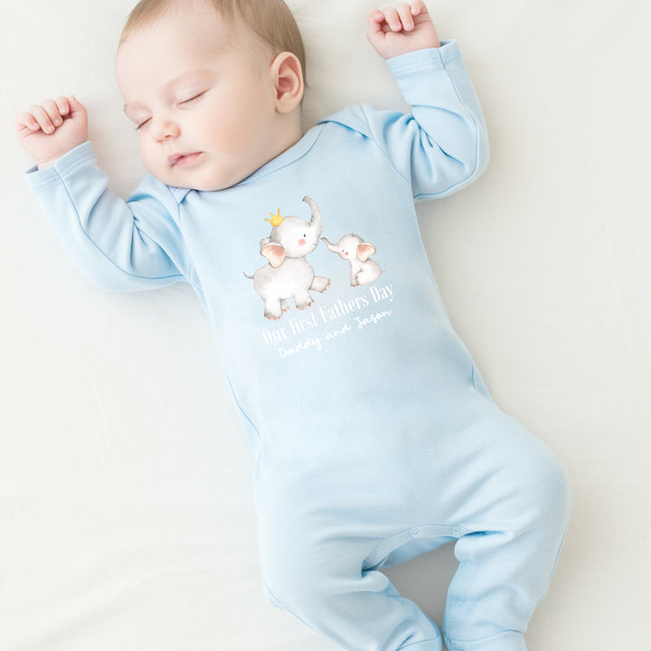 Personalised blue Father's Day baby grow that says 'Our First Father's Day Daddy and Jason'. This design features 2 elephants