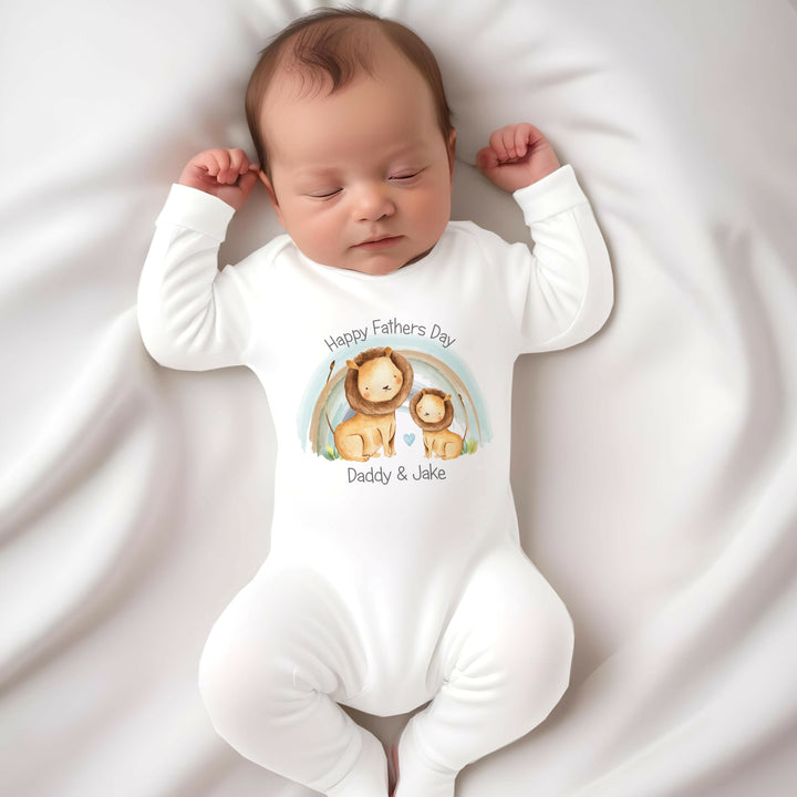 Personalised white Father's Day baby grow/sleepsuit that says 'Happy Fathers  Day Daddy & Jake'. This design features a blue rainbow and 2 lions 