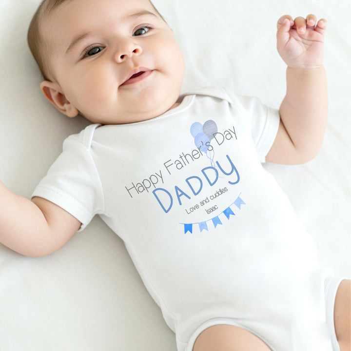 Personalised white Father's Day baby vest that says 'Happy Father's Day Daddy Love and Cuddles Issac'. This design features blue banners and balloons