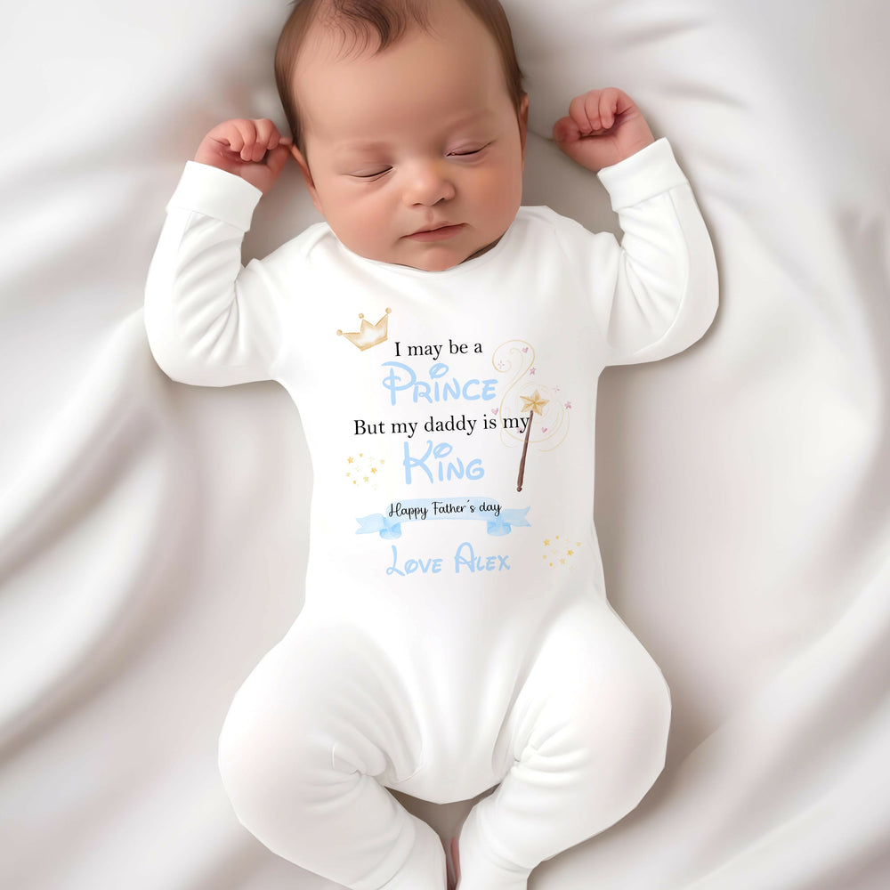 Personalised white Father's Day baby grow/sleepsuit that says 'I may be a Prince But my daddy is my King Happy Father's Day Love Alex'. This design features a crown and a wands