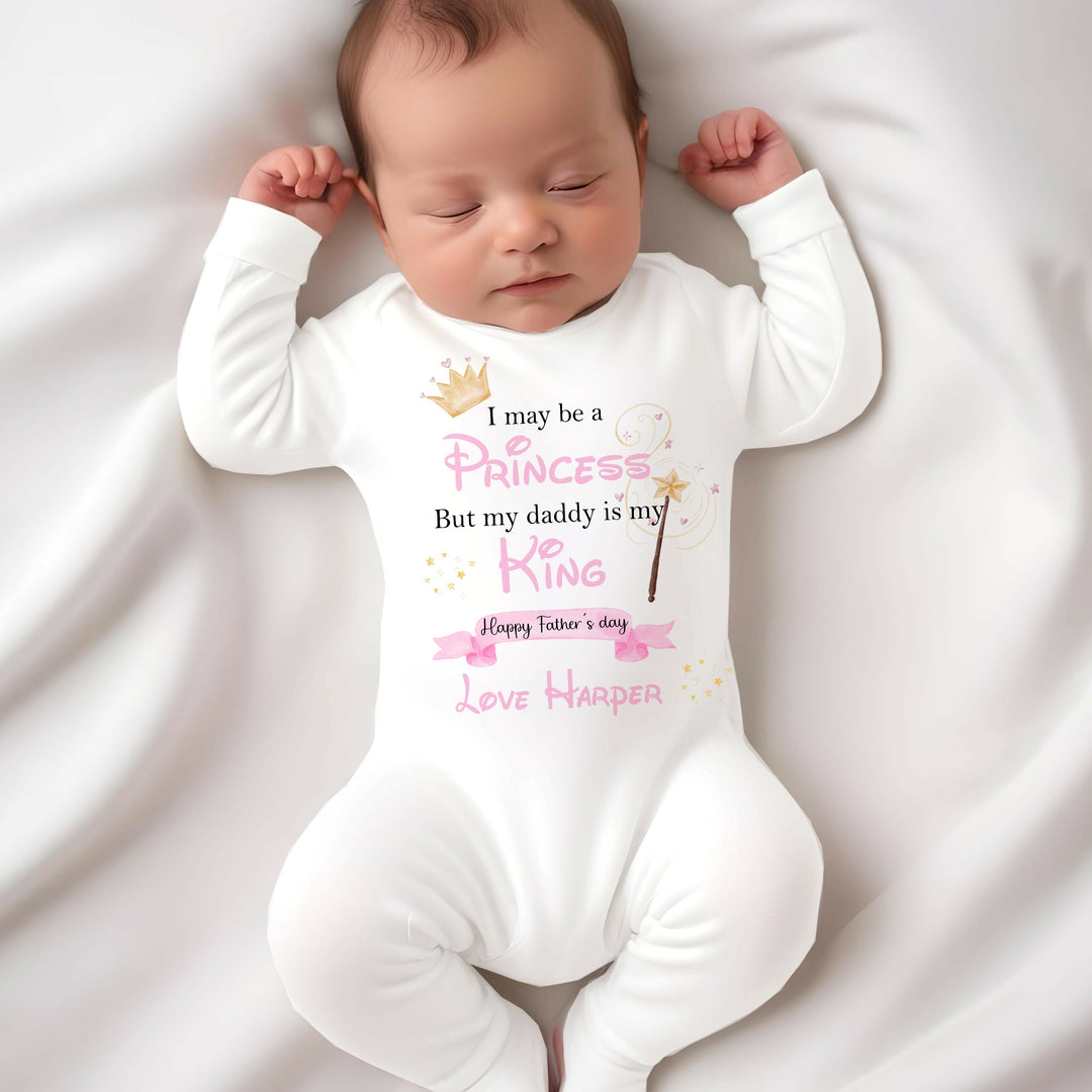 Personalised white Father's Day baby grow that says ' I may be a Princess But my Daddy is my King Happy Father's Day Love Harper'. This design features a crown and a fairy wand