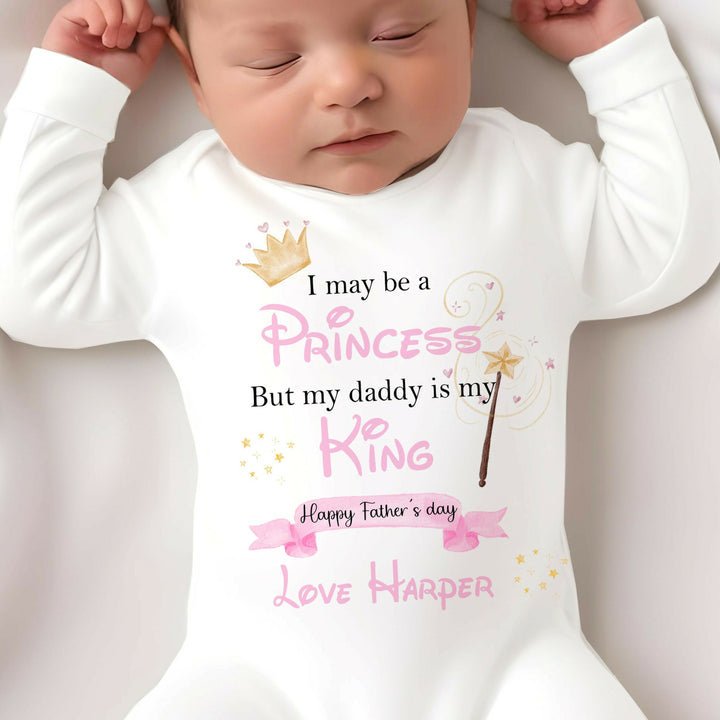 Personalised white Father's Day baby grow that says ' I may be a Princess But my Daddy is my King Happy Father's Day Love Harper'. This design features a crown and a fairy wand