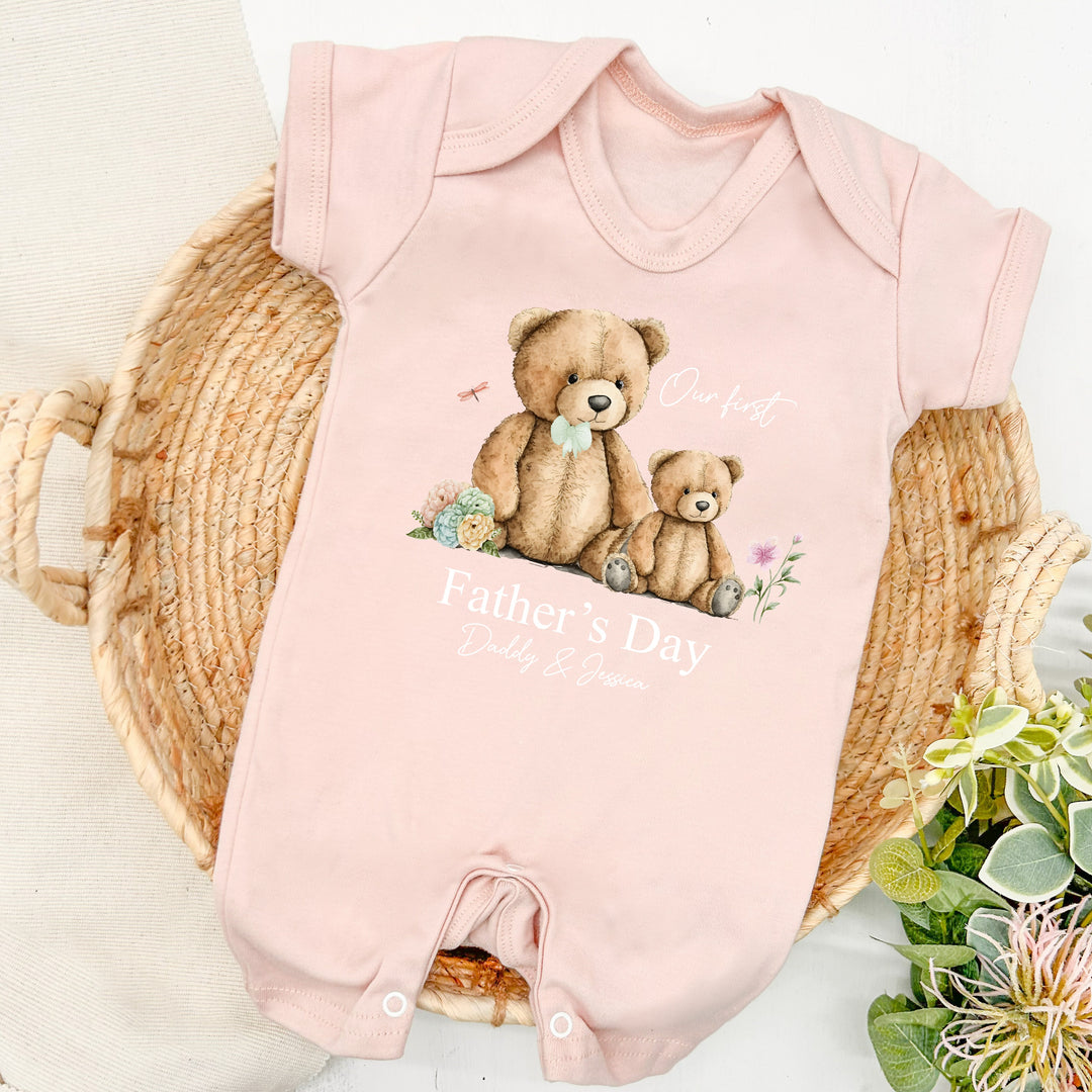 Personalised pink Father's Day baby romper that says 'Our First Father's Day Daddy & Jessica'. This design features a big teddy bear wearing a sage green bow tie sitting next to a small teddy bear