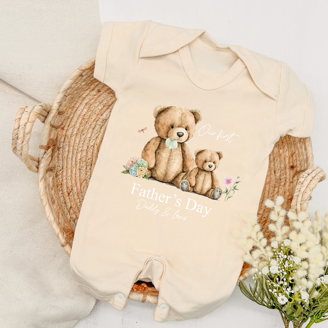 Personalised beige Father's Day baby romper that says 'Our First Father's Day Daddy & Louis'. This design features a big teddy bear wearing a sage green bow tie sitting next to a small teddy bear