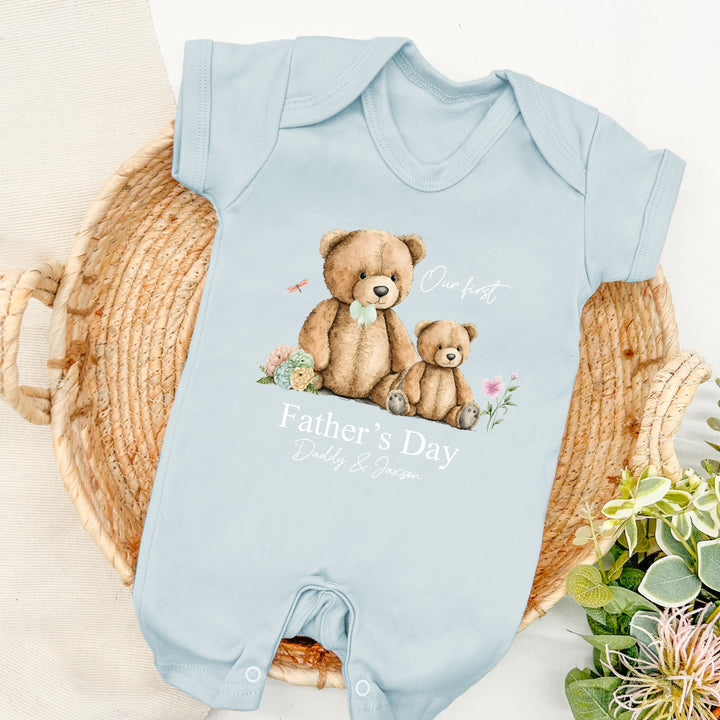 Personalised blue Father's Day baby romper that says 'Our First Father's Day Daddy & Jaxson'. This design features a big teddy bear wearing a sage green bow tie sitting next to a small teddy bear